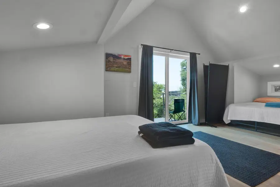 Bedroom featuring recessed lighting, wood finished floors, and vaulted ceiling