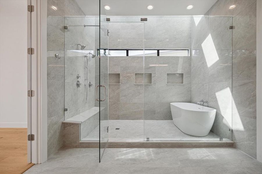 Primary bath wet room with double shower heads, rain head, and hand shower, a large soaker tub.  Luxurious and relaxing way to unwind in the evening or to prepare for a new day.