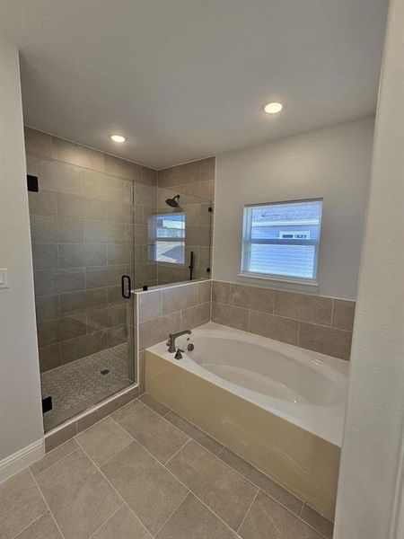 Bathroom with independent shower and bath and tile patterned flooring