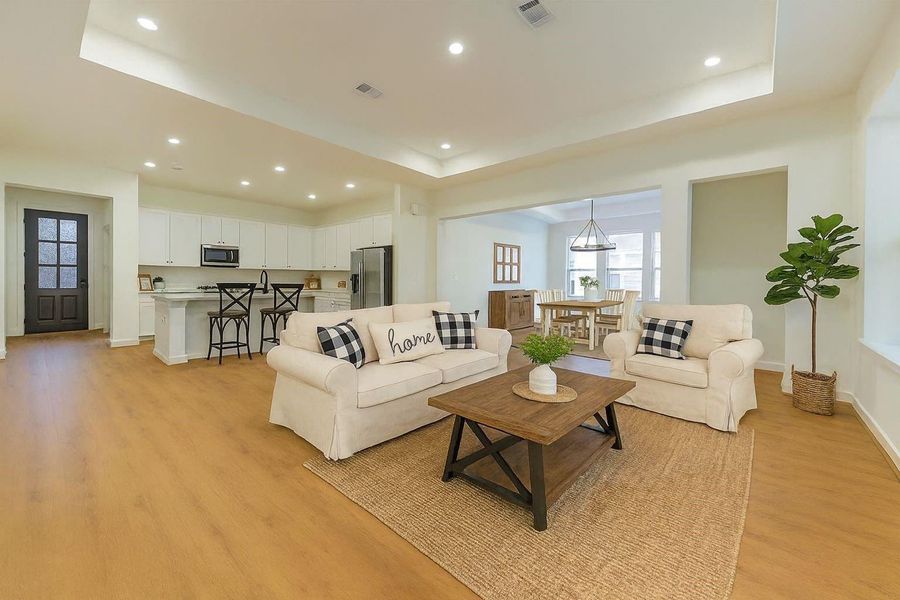 Discover with staging what this home can be, a bright, inviting den with sleek hardwood floors, cozy seating, and seamless flow into a modern kitchen—perfect for relaxed living and entertaining. Discover with staging what this home can be, a bright, inviting den with sleek hardwood floors, cozy seating, and seamless flow into a modern kitchen—perfect for relaxed living and entertaining.