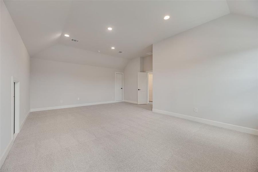 Unfurnished room with light colored carpet, recessed lighting, and high vaulted ceiling