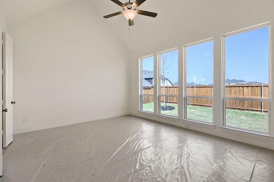 Spare room featuring ceiling fan and lofted ceiling