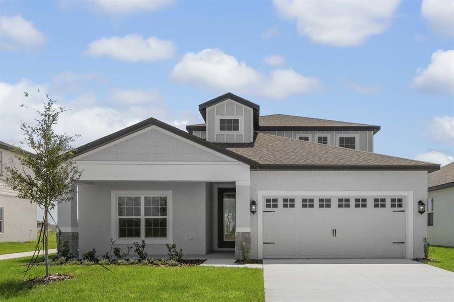 Front exterior of a new home in Gum Lake Preserve, Lake Alfred, FL, highlighting curb appeal (Image 1).
