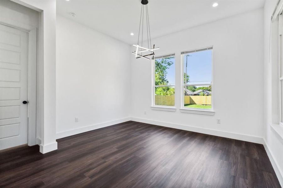 Unfurnished dining area featuring dark hardwood / wood-style flooring