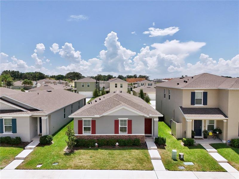 Front exterior of a new home in Windrose, Apopka, FL, highlighting curb appeal (Image 23).