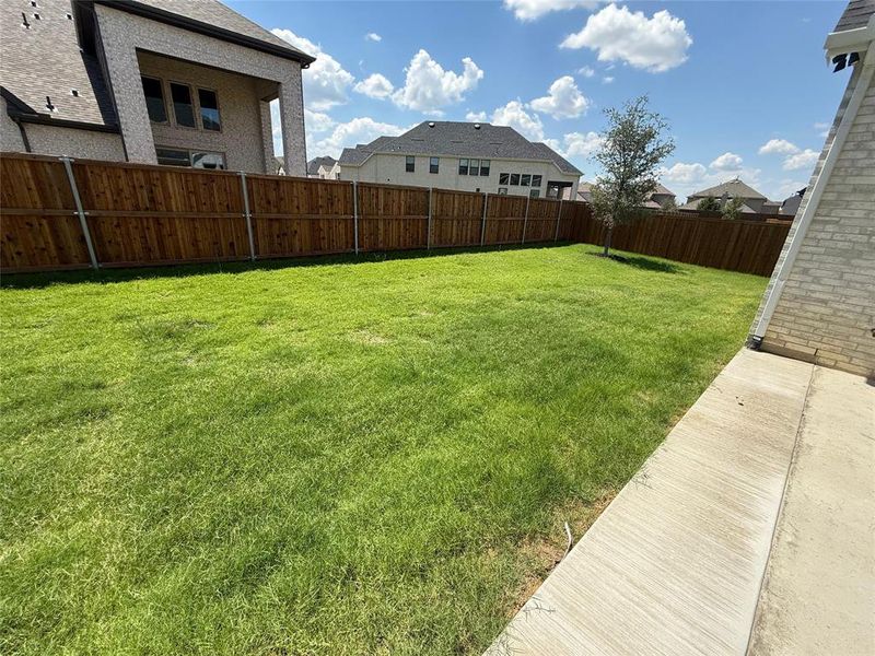 Fenced backyard featuring a residential view Fenced backyard featuring a residential view