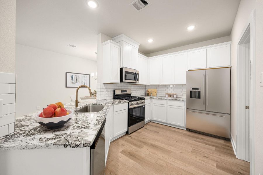 The kitchen features crisp white cabinetry, sleek countertops, and stainless steel appliances that complement the clean design. The open layout allows for easy flow into adjoining spaces, while recessed lighting and a stylish black faucet add a touch of sophistication. A walk-in pantry offers ample storage, combining functionality with contemporary charm. The kitchen features crisp white cabinetry, sleek countertops, and stainless steel appliances that complement the clean design. The open layout allows for easy flow into adjoining spaces, while recessed lighting and a stylish black faucet add a touch of sophistication. A walk-in pantry offers ample storage, combining functionality with contemporary charm.
