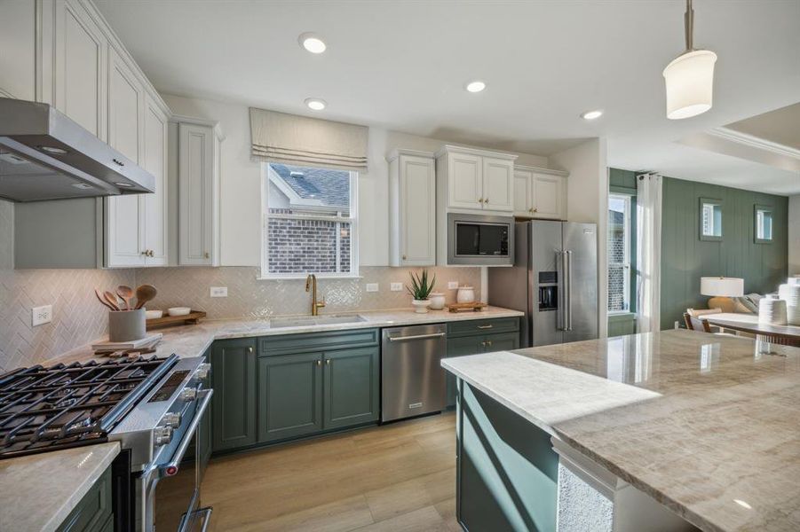 *Model Representation - Large island overlooking gathering room and dining areas