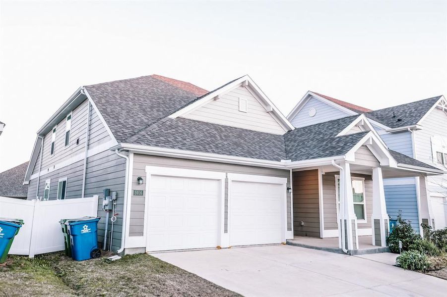 View of front facade featuring a garage and covered porch