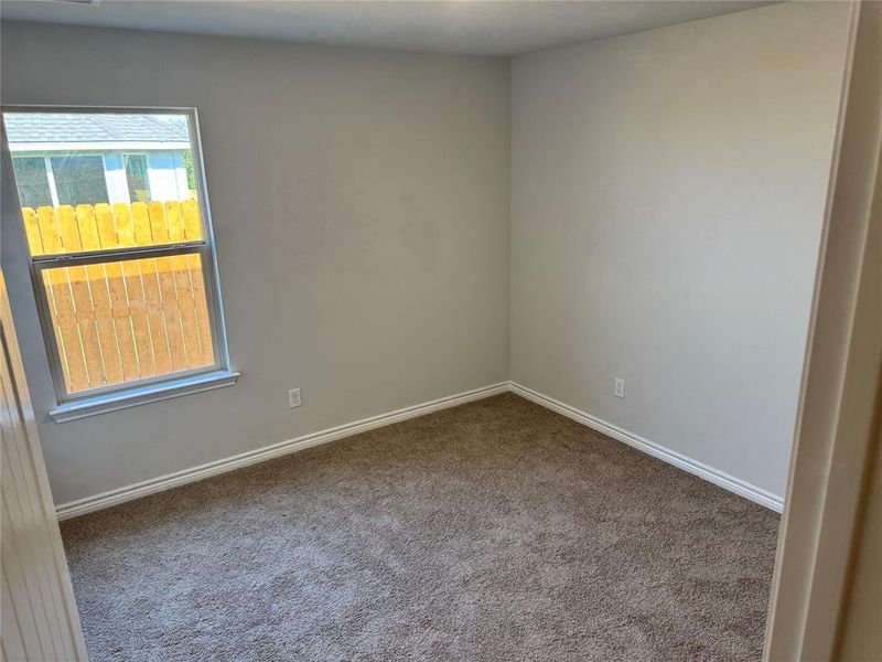 Unfurnished room with carpet flooring and baseboards