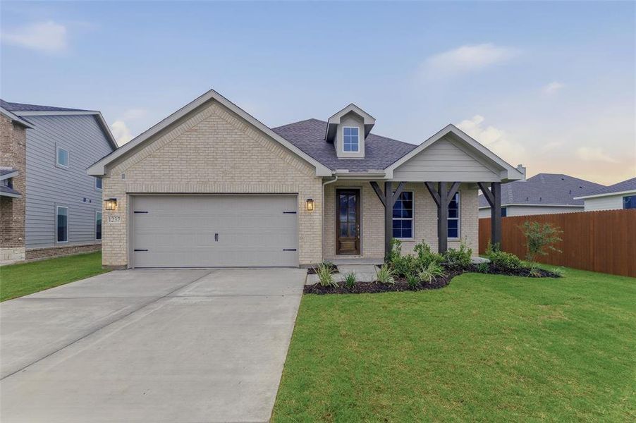 Light brick exterior with an attached two-car garage