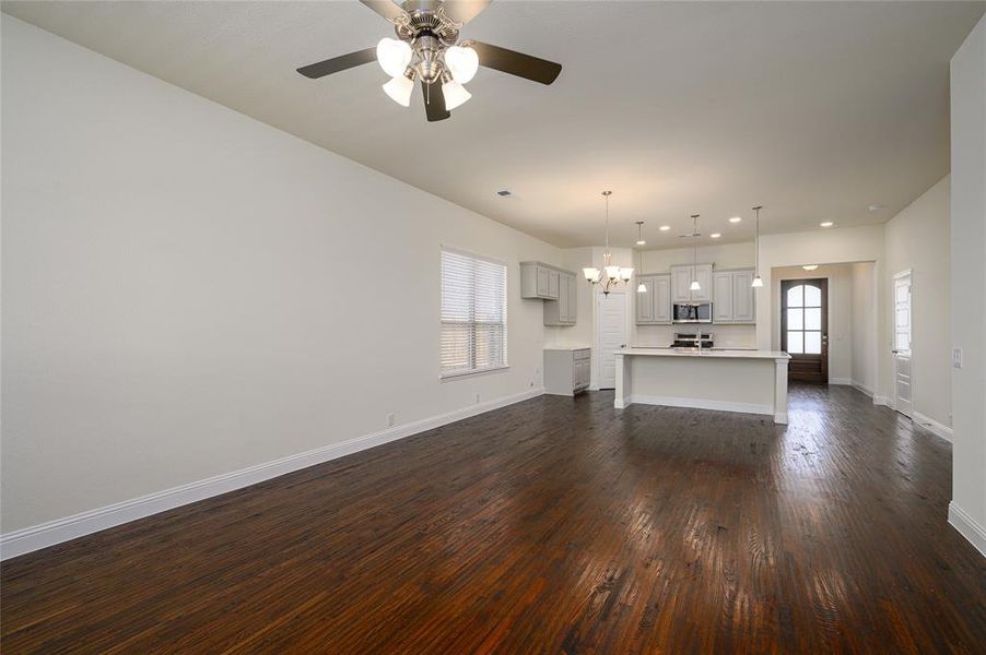 Family room featuring hand scraped flooring and ceiling fan