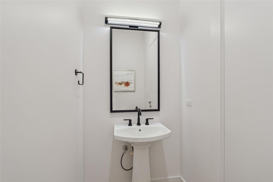 Convenient powder bath located just off the kitchen and living room. Convenient powder bath located just off the kitchen and living room.