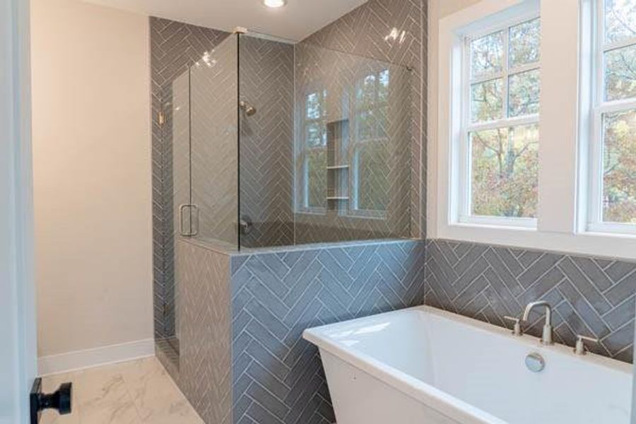 Bathroom with shower with separate bathtub and tile floors Bathroom with shower with separate bathtub and tile floors