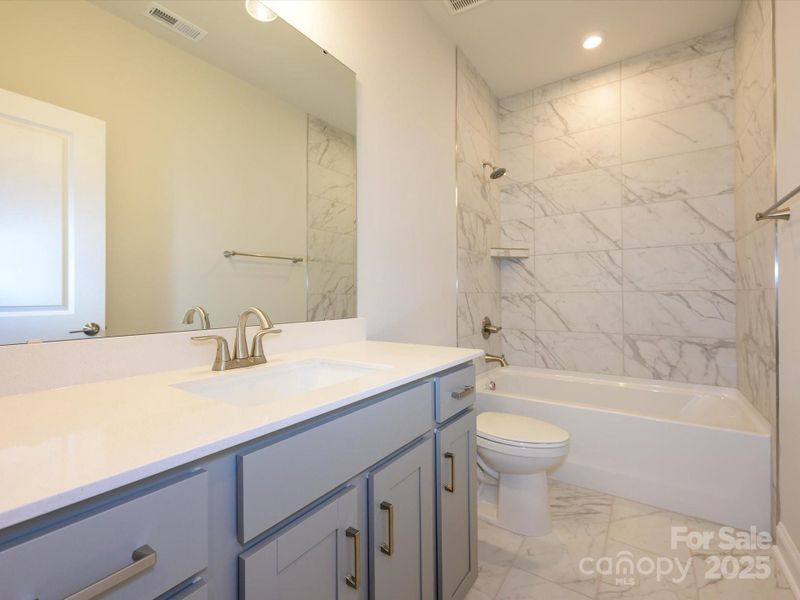 Secondary Bathroom With Upgraded Tile Surround Shower.