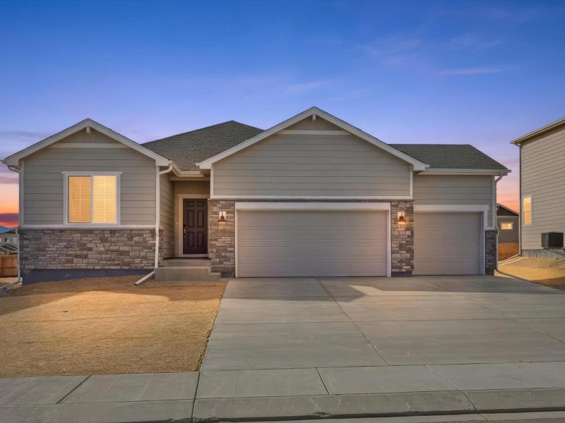 Front exterior of a new home in Paint Brush Hills, Peyton, CO, highlighting curb appeal (Image 1). Front exterior of a new home in Paint Brush Hills, Peyton, CO, highlighting curb appeal (Image 1).