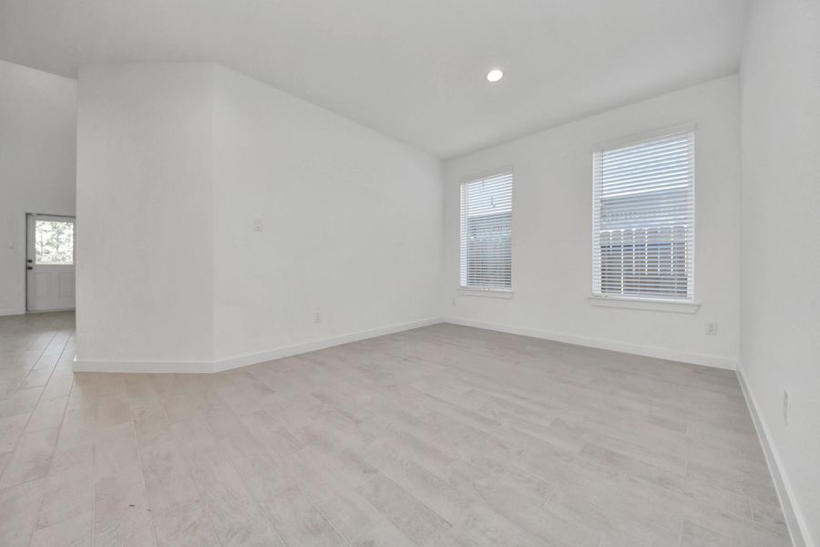 Make memories gathered around the table with your family and friends! This spacious dining room features elegant flooring, custom paint, and adjacent to family room and kitchen for open concept feel. Sample photo of completed home with similar floor plan. Actual colors and selections may vary.