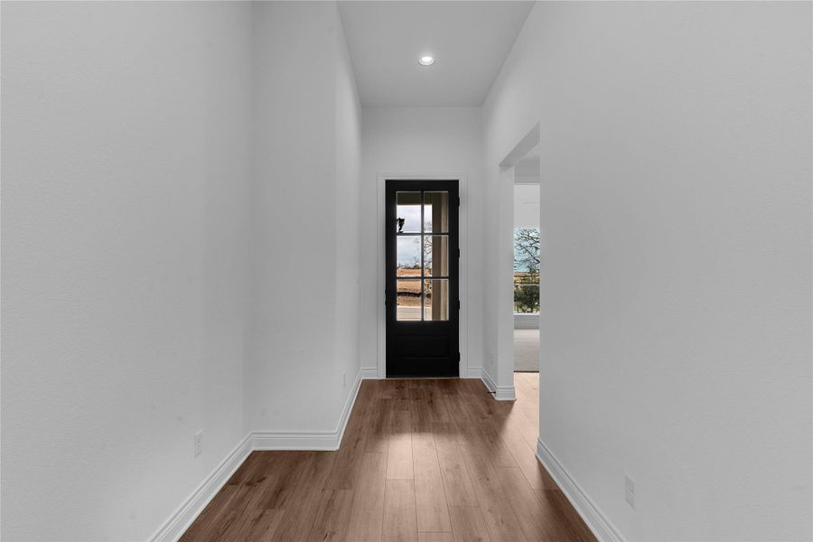 Doorway to outside featuring wood finished floors and recessed lighting