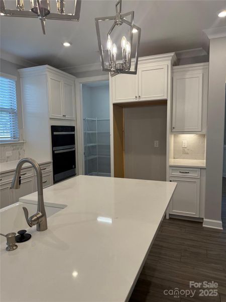 Pendants over island looking toward walk in pantry