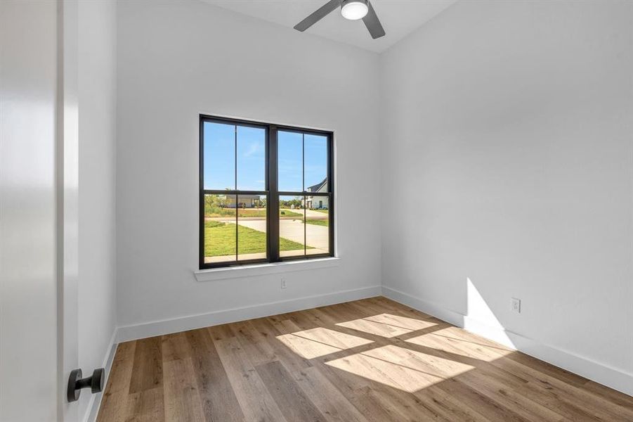 Bedroom with light wood-style floors and a ceiling fan