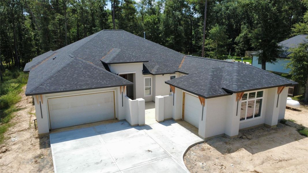 Front exterior of a new home in , Splendora, TX, highlighting curb appeal (Image 1).