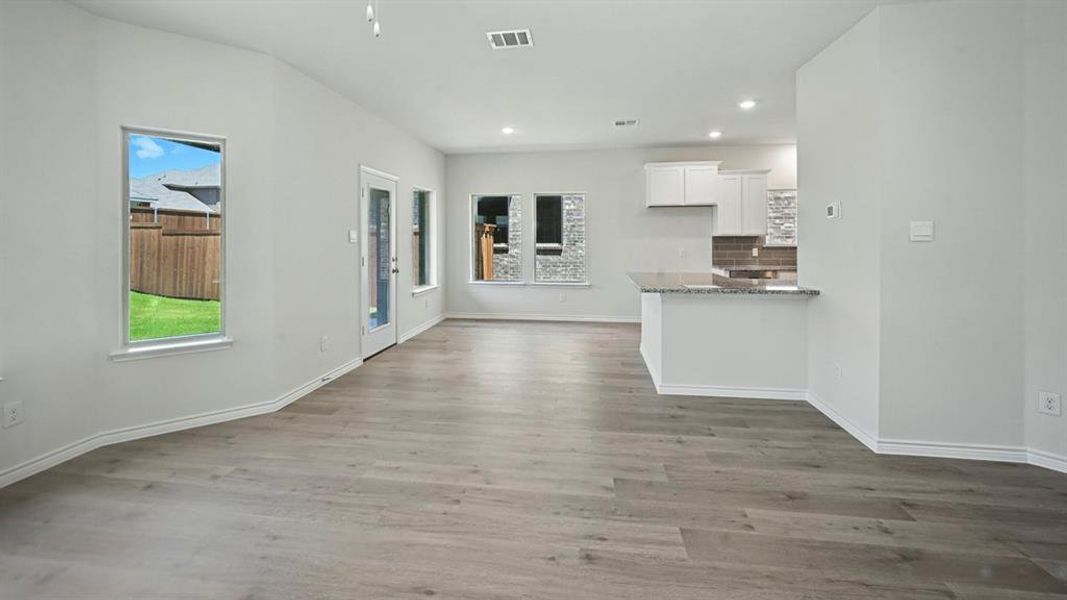 Unfurnished living room with light wood finished floors and recessed lighting