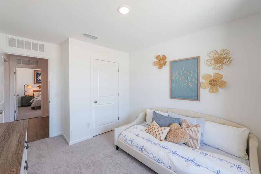 A room with a couch and a mirror. A room with a couch and a mirror.