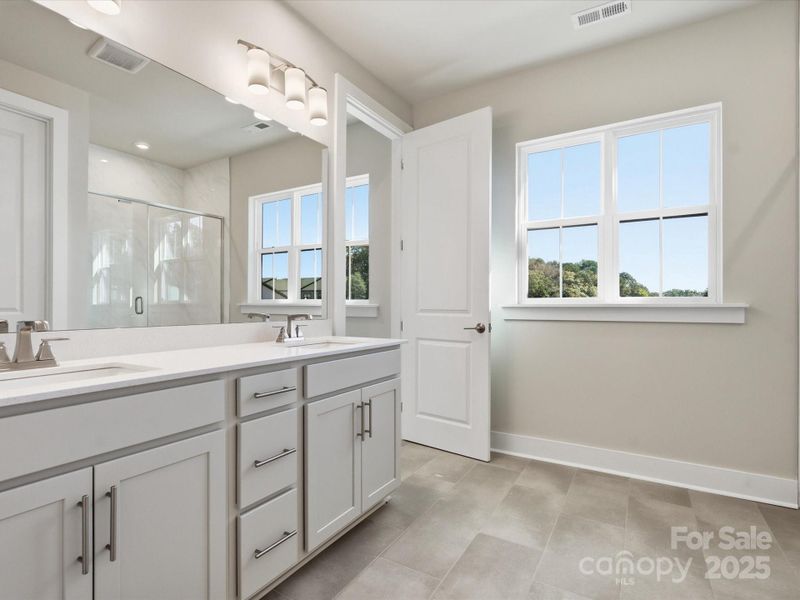 Large Bright Window at Bath Brightens Up the Space.