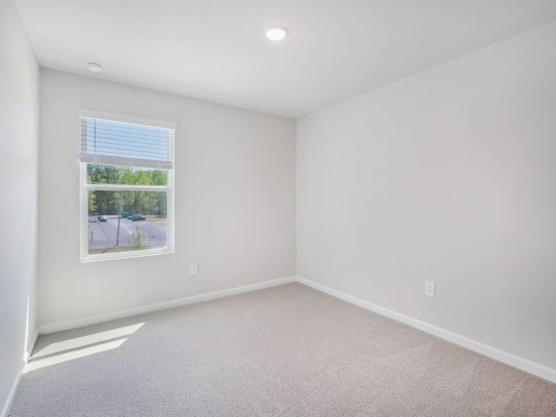 Two secondary bedrooms are ideally situated away from the primary suite.