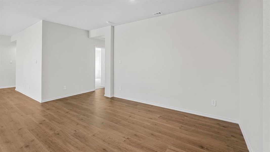 Unfurnished room featuring dark wood-style floors and baseboards