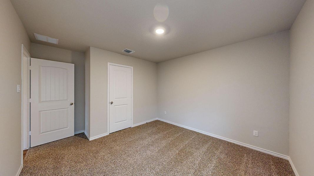 Unfurnished bedroom featuring carpet flooring and baseboards