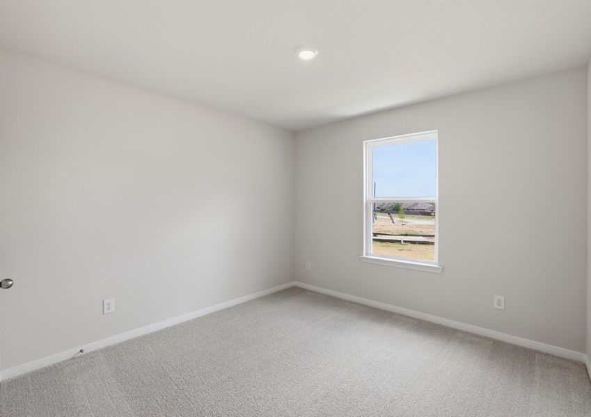 Secondary bedroom featuring carpet flooring and a window with natural light.