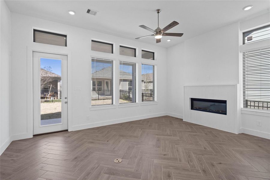 The great room features a fireplace, tall ceilings, ceiling fan, abundant natural light with plenty of windows, and an open, inviting ambiance--perfect for gatherings, relaxation, and making memories. The great room features a fireplace, tall ceilings, ceiling fan, abundant natural light with plenty of windows, and an open, inviting ambiance--perfect for gatherings, relaxation, and making memories.