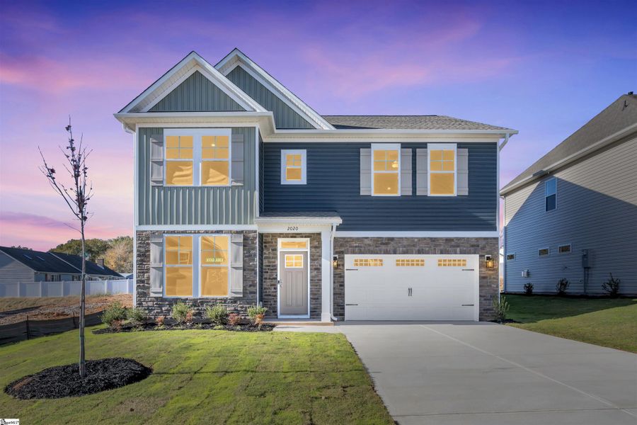 Front exterior of a new home in Halton Oaks, Spartanburg, SC, highlighting curb appeal (Image 1).