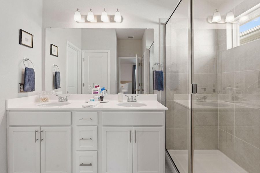 Full bath with double vanity and a shower stall Full bath with double vanity and a shower stall