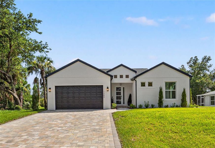 Front exterior of a new home in , North Port, FL, highlighting curb appeal (Image 31). Front exterior of a new home in , North Port, FL, highlighting curb appeal (Image 31).