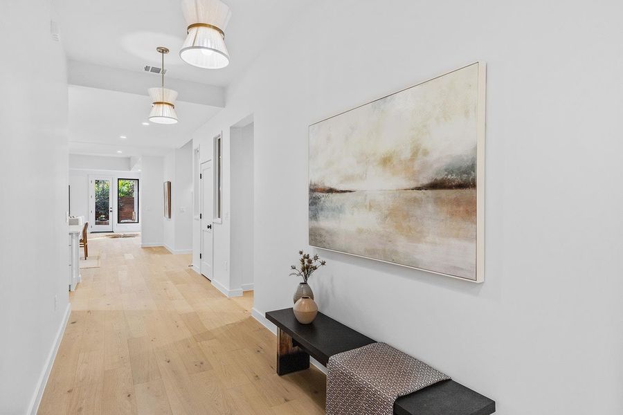 Hall featuring light wood-type flooring and recessed lighting