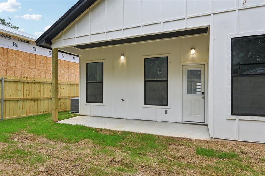 Back of property with board and batten siding and a patio Back of property with board and batten siding and a patio