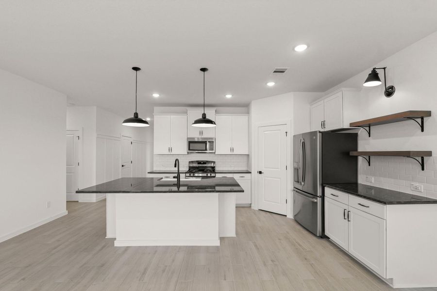 Gorgeous kitchen with granite counters and stylish floating shelves Gorgeous kitchen with granite counters and stylish floating shelves