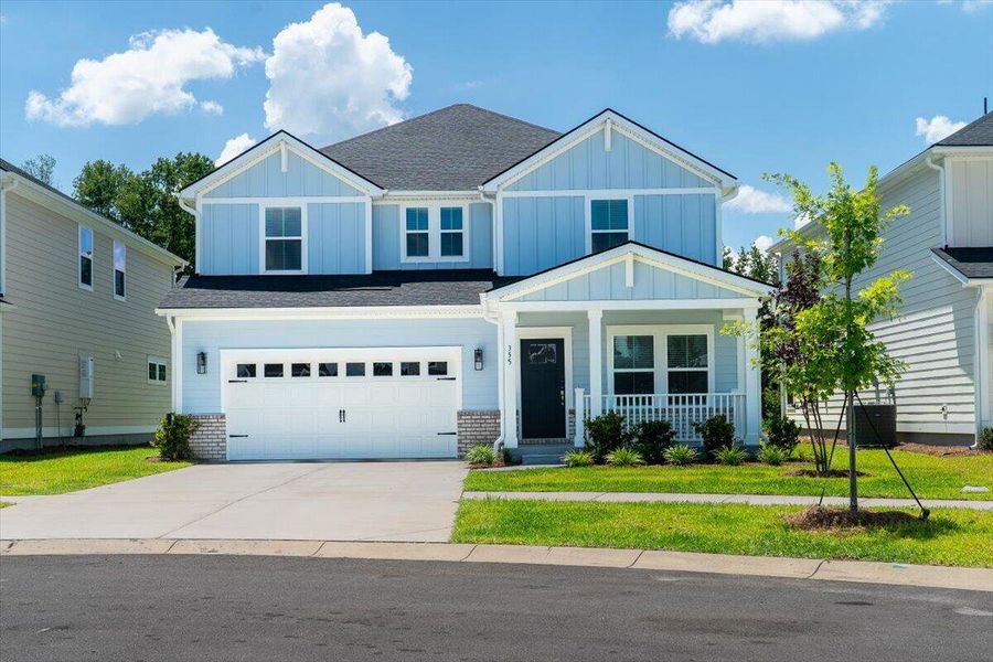Front exterior of a new home in The Coves at Lakes of Cane Bay, Summerville, SC, highlighting curb appeal (Image 21). Front exterior of a new home in The Coves at Lakes of Cane Bay, Summerville, SC, highlighting curb appeal (Image 21).