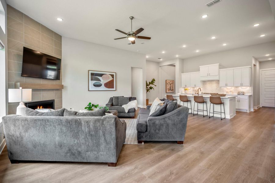 Impressive from every angle, this open airy space brings the kitchen, dining area and family room together in one bright, polished setting. LVP flooring flows throughout, while the raised ceiling with recessed lighting adds an airy feel and plenty of room lets everyone cook, dine, gather and relax with ease.