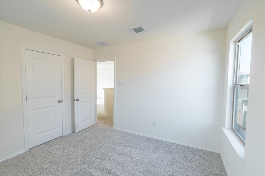 A well-lit bedroom with ample natural illumination from the window. A well-lit bedroom with ample natural illumination from the window.