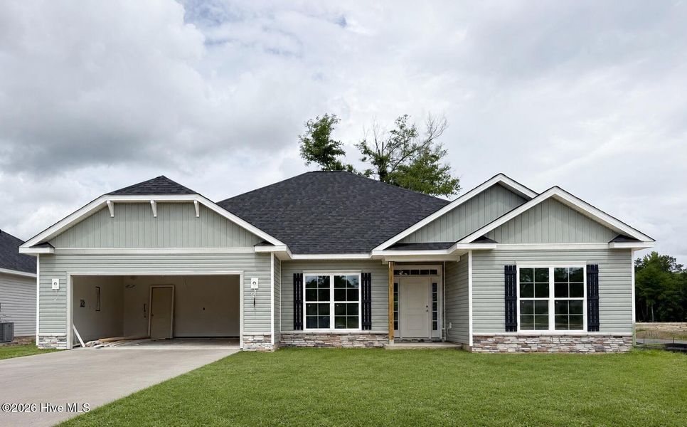 Front exterior of a new home in Wood Creek Landing, Leland, NC, highlighting curb appeal (Image 1). Front exterior of a new home in Wood Creek Landing, Leland, NC, highlighting curb appeal (Image 1).
