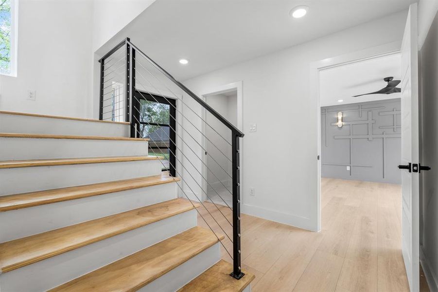 Staircase featuring recessed lighting, wood finished floors, and baseboards