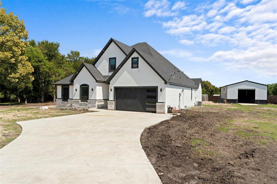 View of front of home with a garage, stucco siding, and driveway View of front of home with a garage, stucco siding, and driveway
