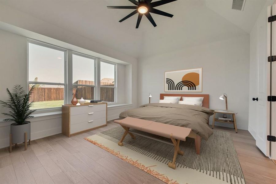 Bedroom with light wood-style floors, vaulted ceiling, and ceiling fan Bedroom with light wood-style floors, vaulted ceiling, and ceiling fan