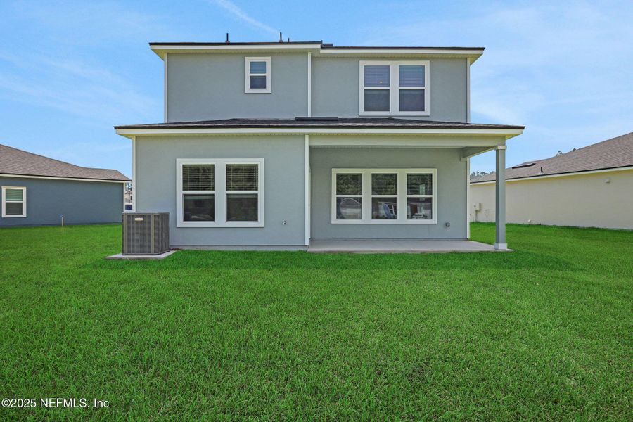 Front exterior of a new home in Amberly, Green Cove Springs, FL, highlighting curb appeal (Image 2).