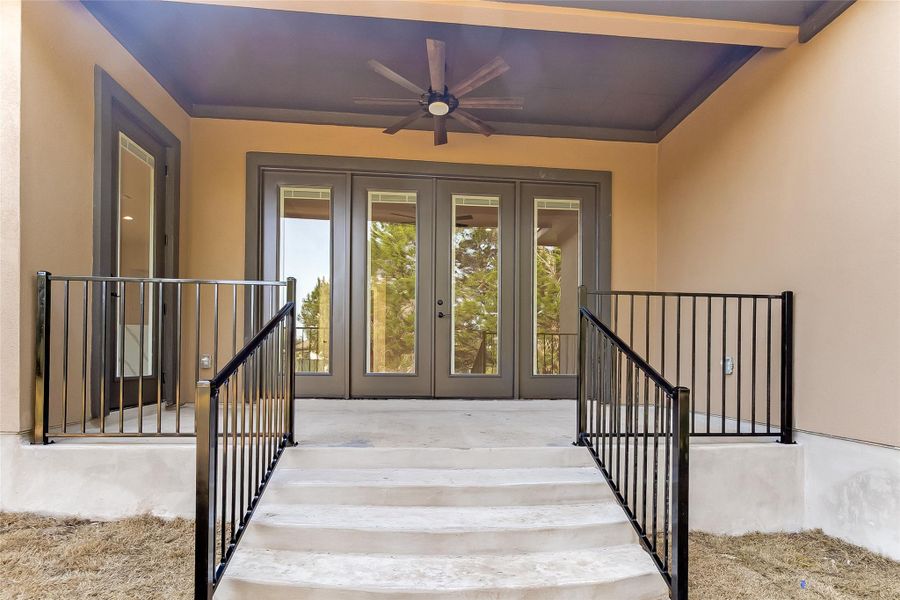 Doorway to property featuring stucco siding, french doors, and ceiling fan Doorway to property featuring stucco siding, french doors, and ceiling fan
