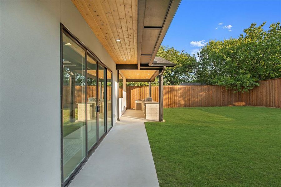 Fenced backyard featuring a patio area Fenced backyard featuring a patio area