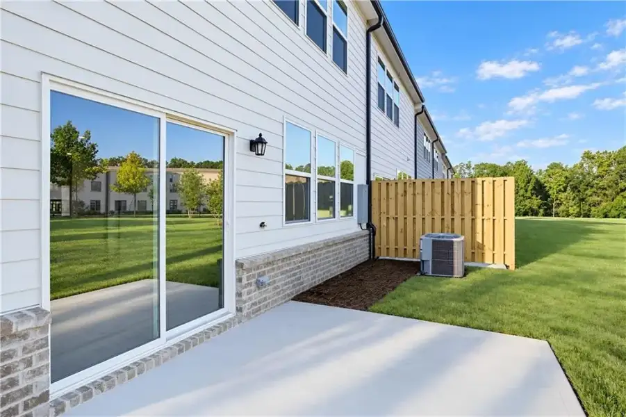 Exterior details and patio area of a home in Towns at Holly Springs, Holly Springs (Image 3).